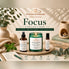 Nurse Calm Aromatherapy Focus Collection featuring Sensaytional green jar soy candle, Focus Fuel Atmosphere Mist, and essential oil roller.