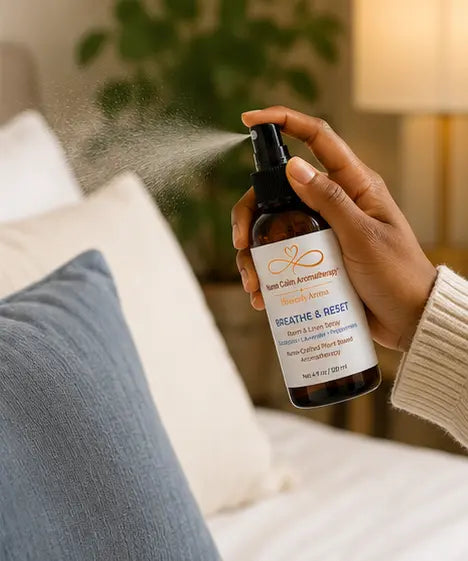 Hand using Breathe & Reset Room & Linen Spray to refresh a room with a botanical mist.