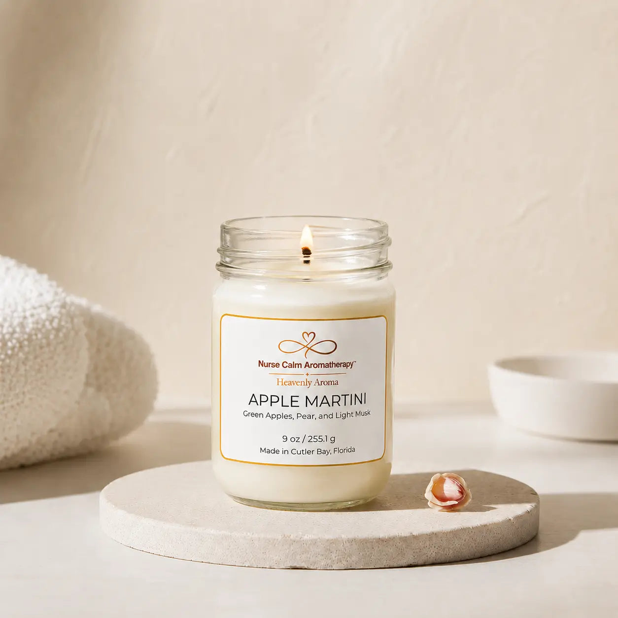 Apple Martini candle burning on cream spa décor