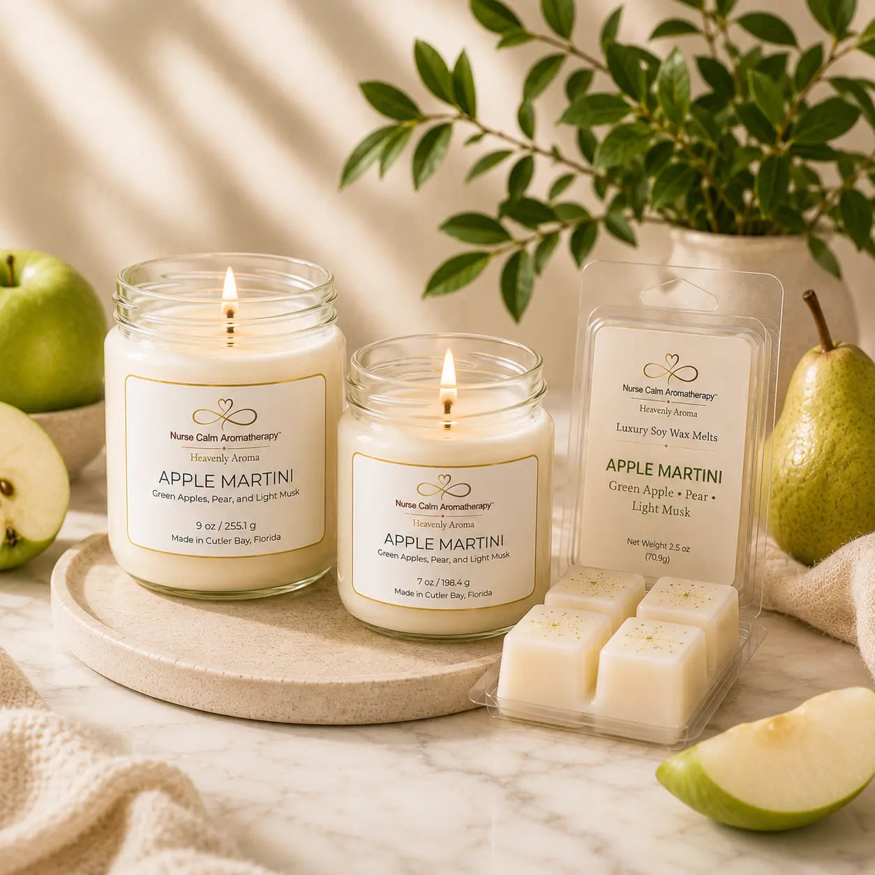 Apple Martini Complete Signature Collection featuring 9 oz and 7 oz handcrafted soy candles with an Apple Martini luxury soy wax melt on a cream marble background with fresh green apples and pears.
