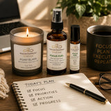 Focus & Energy Ritual wellness bundle styled in a productive workspace with Point Blank candle, Focus Fuel aromatherapy products, coffee, and a planning journal.