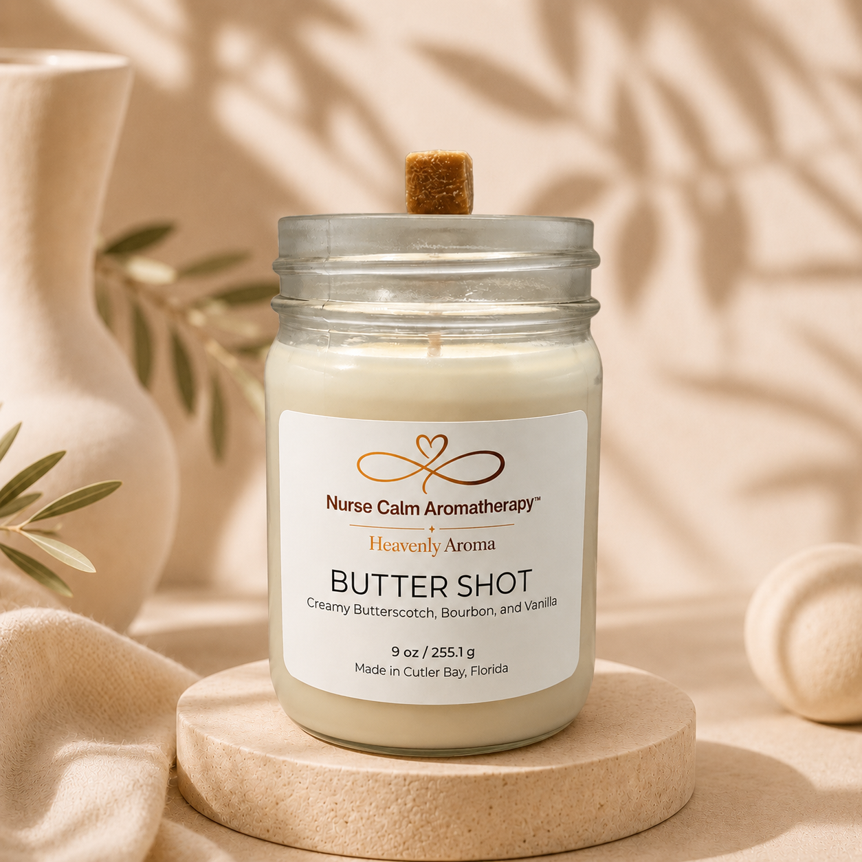 Nurse Calm Aromatherapy candle in a jar on a wooden stand with a neutral background