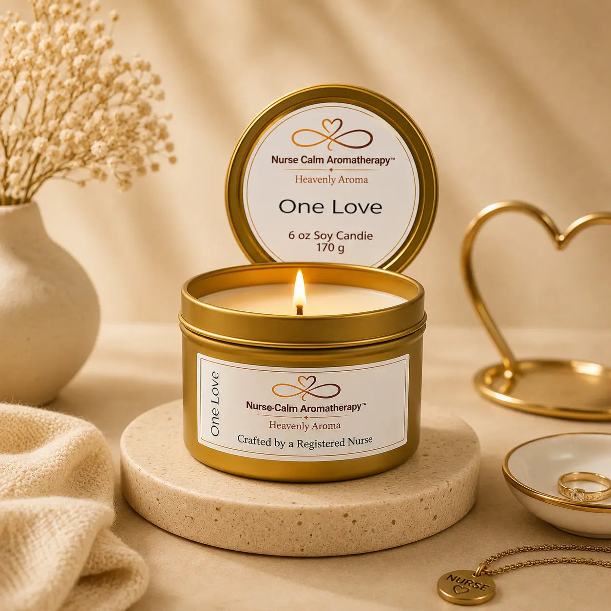 Nurse Calm Aromatherapy candle labeled 'One Love' with a lit candle inside a gold tin on a beige surface.